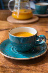Close up of healthy tea infusion in a tea cup on wooden table