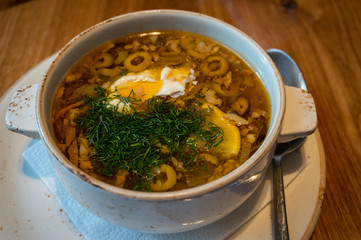 Borscht or borsht soup in a rustic bowl with sour cream and dill