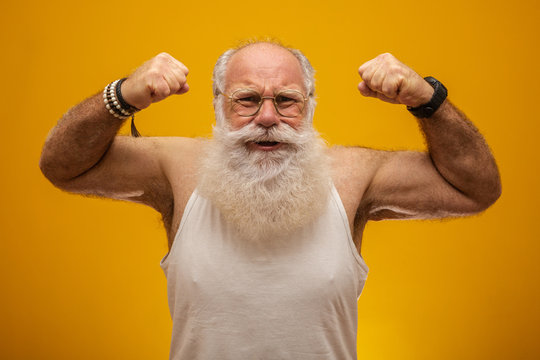 Old man with a long white beard cheering or happy. Winner. Won the lottery.