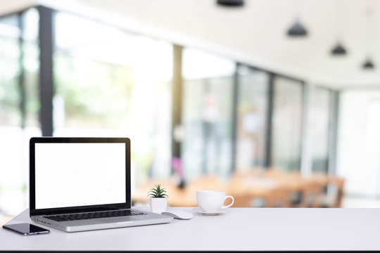 Desk Laptop with blank screen on table  blur background with bokeh background