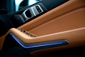 brown luxury leather car door handle modern design with blue light .