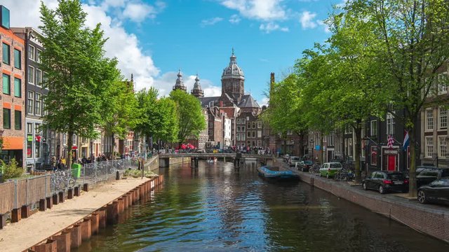 Saint Nicholas Church with Canal and Dutch buildings in Amsterdam city, Netherlands