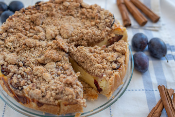 Fresh plum cheesecake with cinnamon and almond crumble