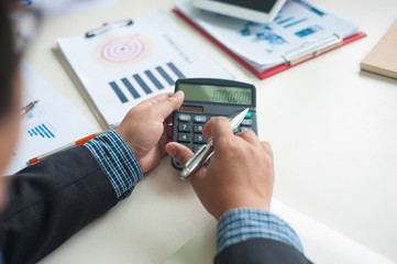 Businessmen calculate and analyze business profits while planning business strategies.