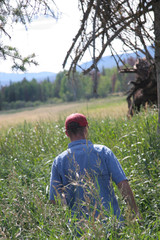 Farmer walking through field 