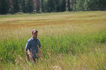 Farmer walking through field 
