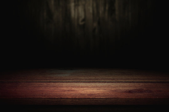 Old wood table on blurred wall background.