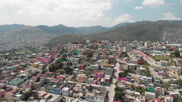 Aerial view of the colorful houses in Ecatepec, Mexico. Drone flying sideways, right to left