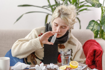 The girl in the sweater is sick lying on the couch. Colds and flu. The patient caught a cold,...