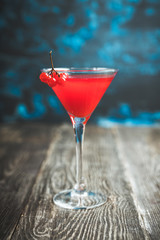 Viburnum martini cocktail with autumn setting on the rustic background. Selective focus. Shallow depth of field.