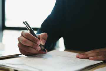 Business man signing a document to agree on financial planning after complete agreement plan in meeting room, investment concept, success concept