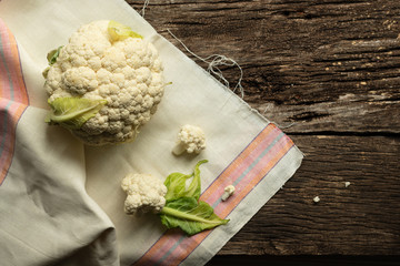 Cooking Cauliflower. Top view, wooden table, a whole head of cauliflower.
