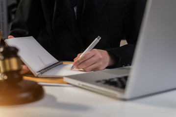 Judge gavel with Justice lawyers, Business woam in suit or lawyer working on a documents. Legal law, advice and justice concept.
