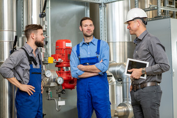  boss with two worker in factory
