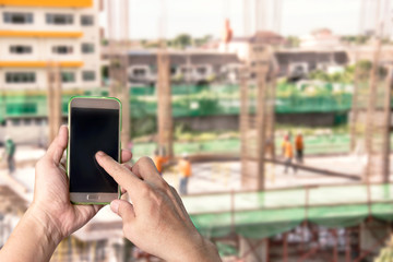Man using mobile  mobile smart phone with blur construction background