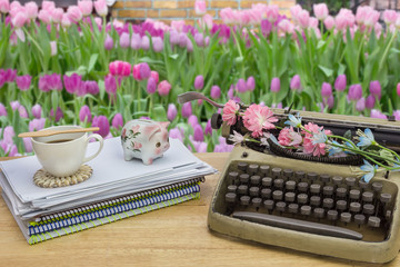 The desk in flower garden background.
