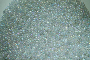 Texture with white beads. Background from beads for needlework. Creative background.