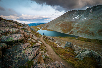 hiker at lake in mountains