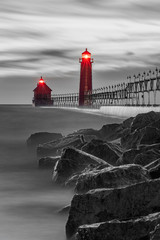 selective color red lighthouses with rocks