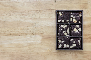package of chocolate brownie on wood background
