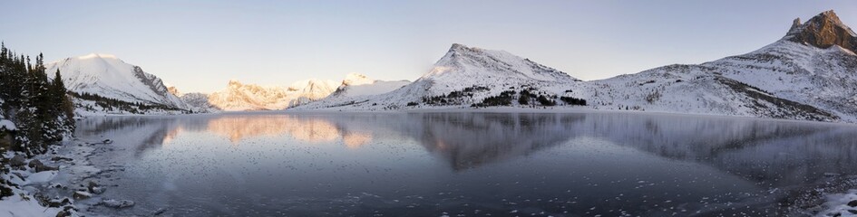 Wide Panoramic Landscape Snowy Mountain Peaks Reflected in Frozen Ptarmigan Lake Ice, Banff...