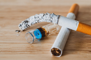 Cigarette holder filter reduce tar on wood desk.