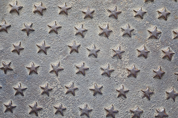 Fototapeta na wymiar Iron stars texture as nice background. Iron cast panel cowered with five-pointed stars pattern.