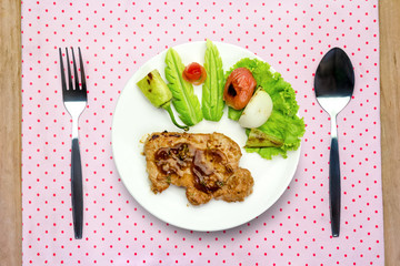 Grilled steak meat with spoon and fork