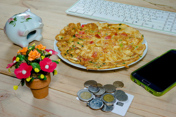 omelet with onion leaves and tomato on desk