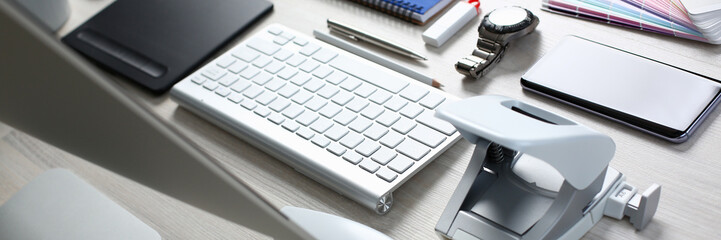 Composition of office worker items on wooden table background closeup