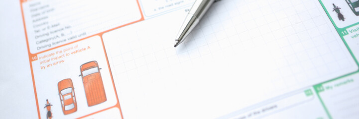 The silver pen is on the international euro-protocol form for filling and indemnification as a result of a traffic accident without police participation concept.