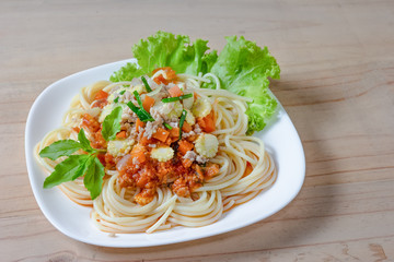 Spaghetti pasta with minced pork on wood background
