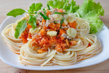 Spaghetti pasta with minced pork on wood background