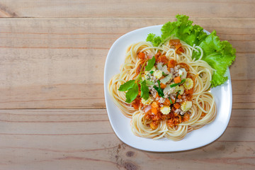 Spaghetti pasta with minced pork on wood background