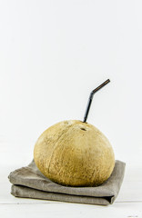 Fototapeta na wymiar coconut with a tube on a white background