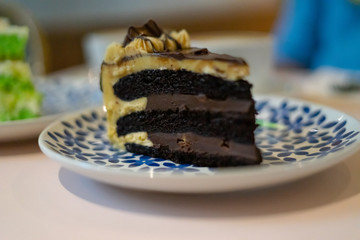 A slice of chocolate cake on the plate. Coffee cake tea time concept.