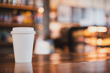 takeaway cup of coffee in coffee shop background