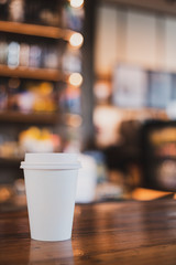 takeaway cup of coffee in coffee shop background