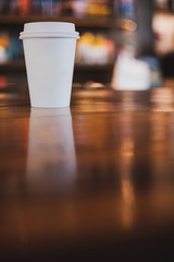 takeaway cup of coffee in coffee shop background