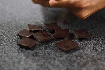 Chef breaking chocolate bar