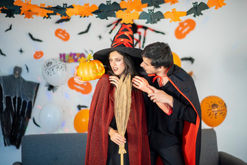 happy couple of love  in costumes and makeup on a celebration of Halloween