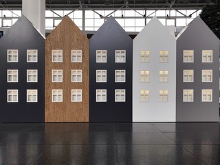 image of several houses cardboard houses with windows. five houses different color. Five Dutch houses in a row