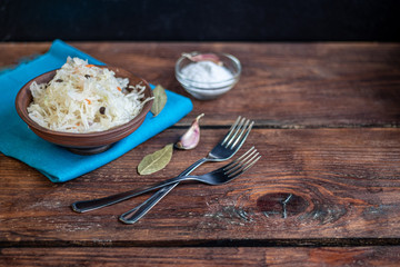 Plate with sour cabbage. This is a useful fermented product. Sour cabbage is rich in vitamins and is used in many dishes of different nations. The fermentation process does not destroy nutrients. 