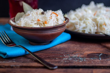 Plate with sour cabbage. This is a useful fermented product. Sour cabbage is rich in vitamins and is used in many dishes of different nations. The fermentation process does not destroy nutrients. 