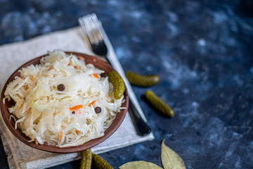 Plate with sour cabbage. This is a useful fermented product. Sour cabbage is rich in vitamins and is used in many dishes of different nations. The fermentation process does not destroy nutrients. 