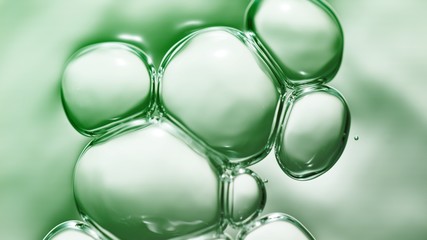 transparent gas bubbles on water surface. Worms-eye low angle with crystal bubbles in purified water on green background. cosmetic backdrop with copy space