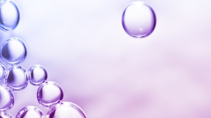 transparent gas bubbles on water surface. Worms-eye low angle with crystal bubbles in purified water on pink, purple, violet background. cosmetic backdrop with copy space