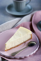 Cheesecake and black coffee and a small cup