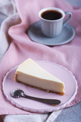 Cheesecake and black coffee and a small cup