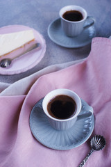 Cheesecake and black coffee and a small cup